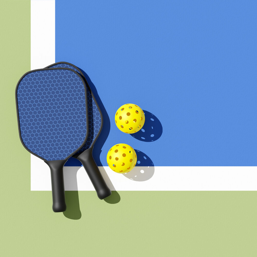 Pickleball paddle and balls on court